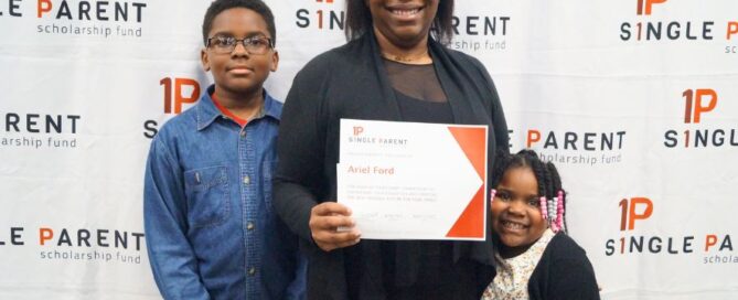 Ariel Ford holds her single parent scholarship with her two children. They stand in front of an ASPSF banner.