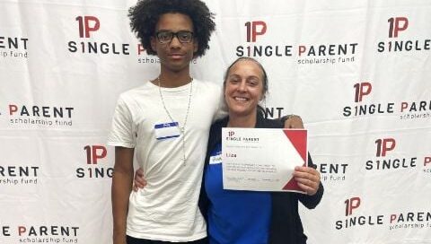 Liza Raible accepts her scholarship with one of her children