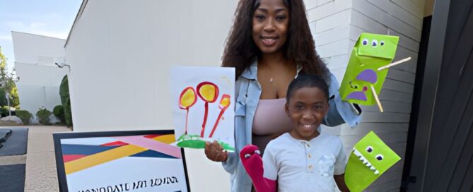 Mom and son hold up his artwork.