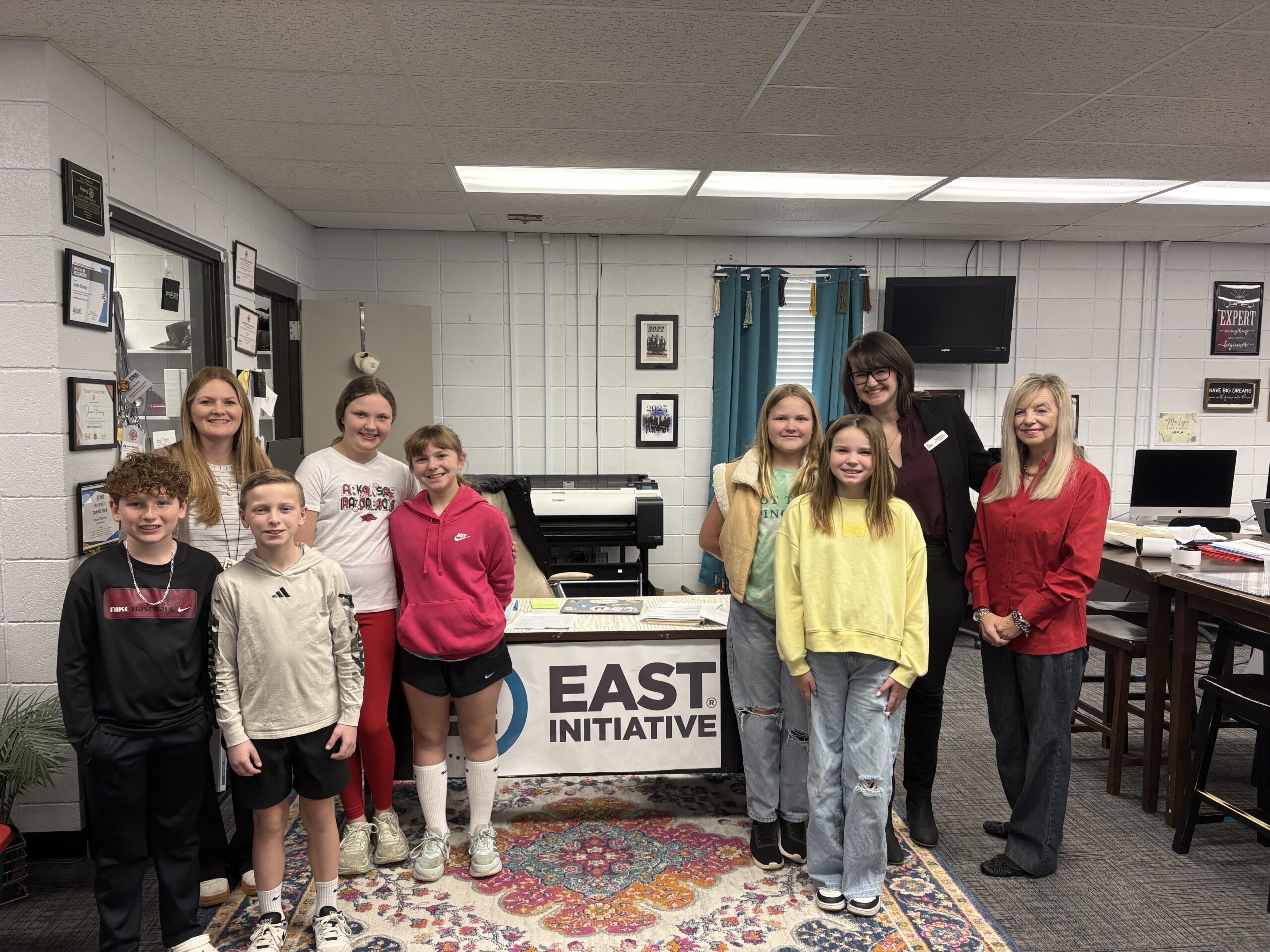 R2-Feb 2026-EAST_Sulphur Rock Elementary (2) Fifth graders and adults stand in a classroom with an EAST Initative sign.