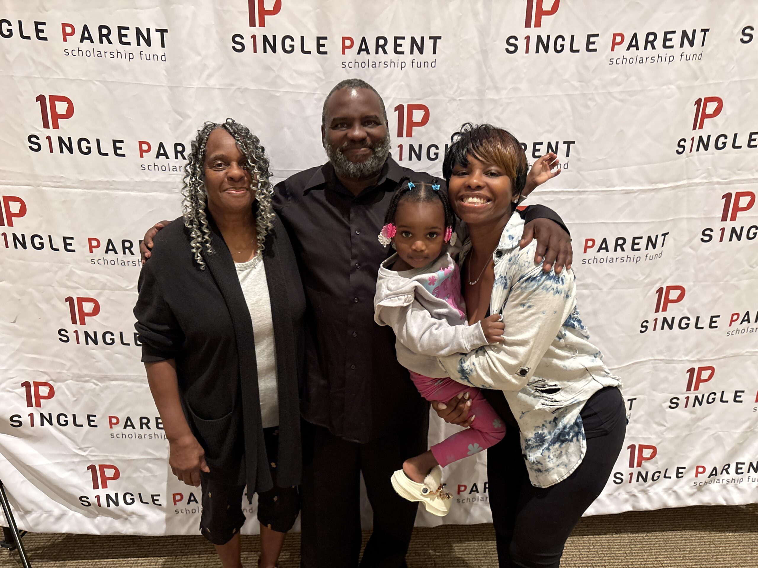 March Student of the Month Kyanna Graham poses with her grandparents and daughter.